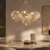 Lampadari Moderni-Selezionato da Mazzolaluce Lampadario oro sfere raggruppate trasparenti ondulate per sala da pranzo contemporanea
