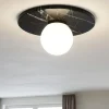 Plafoniere Moderne-Selezionato da Mazzolaluce Plafoniera per camera da letto marmo nero sfera vetro bianco